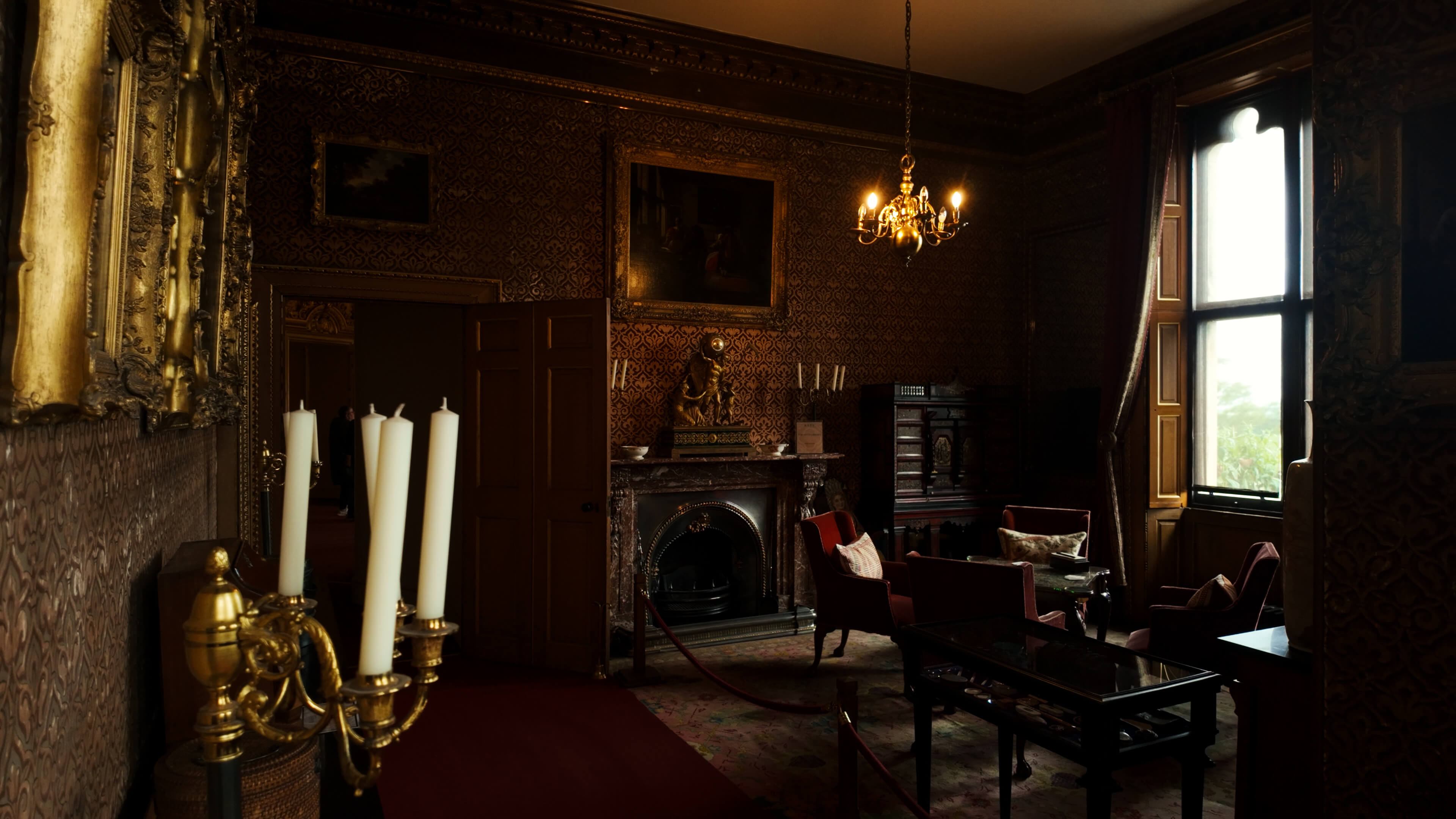 A room showcasing a fireplace, a table, and chairs, designed for comfort and social gatherings