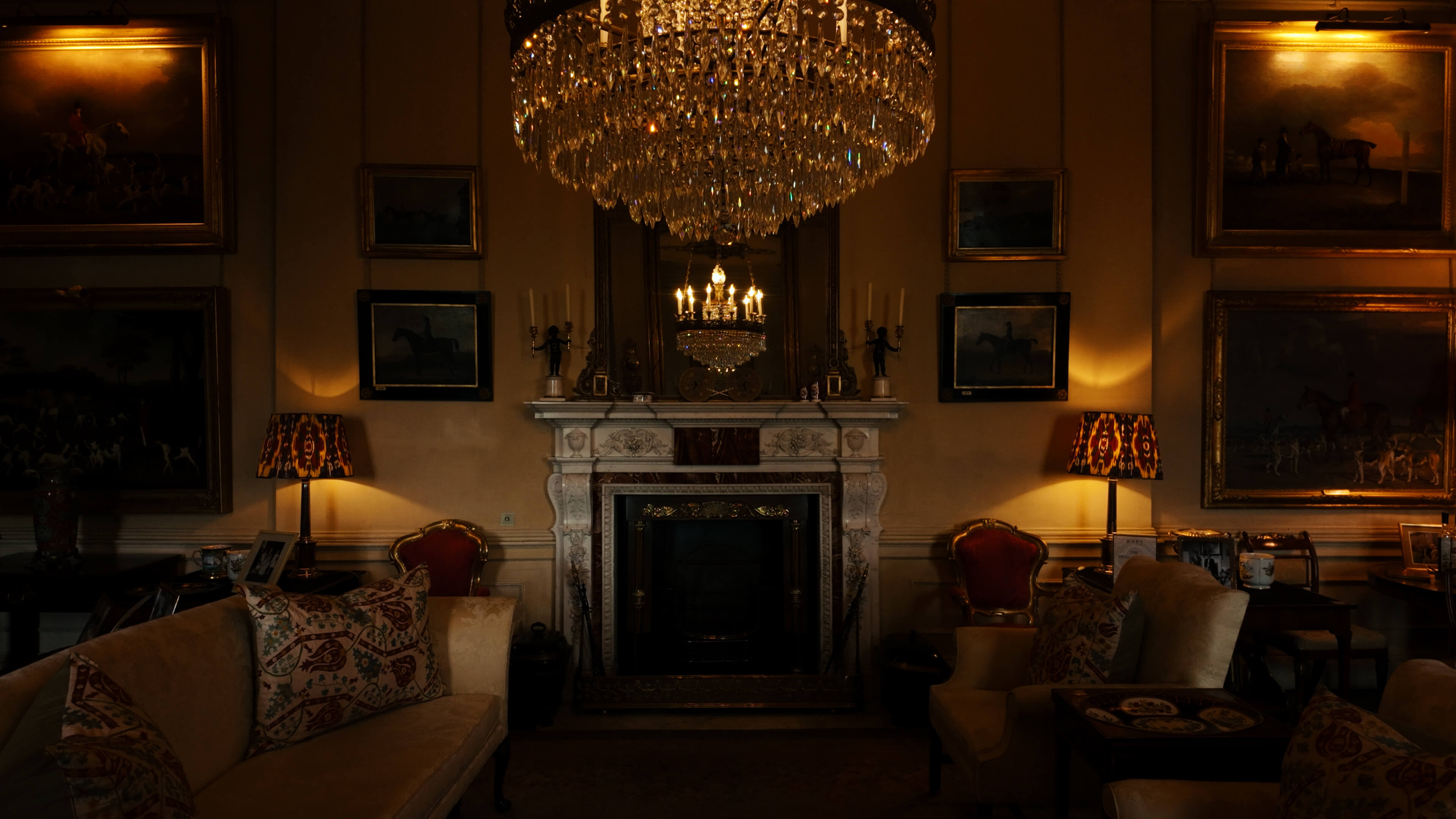 A beautifully decorated room showcasing a fireplace and a stunning chandelier overhead.