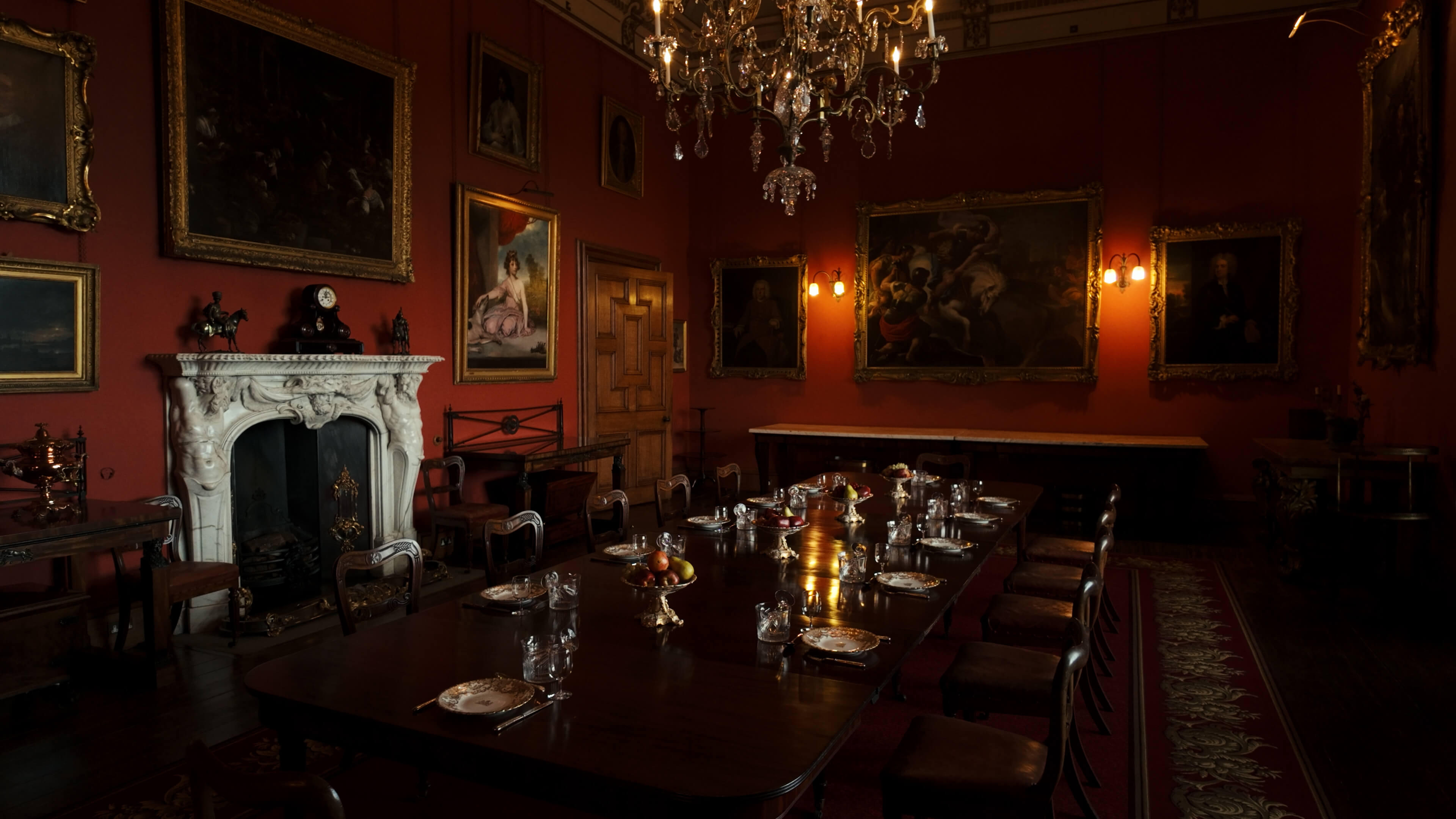 A dining room featuring a wooden table surrounded by four chairs, with soft lighting creating a warm atmosphere