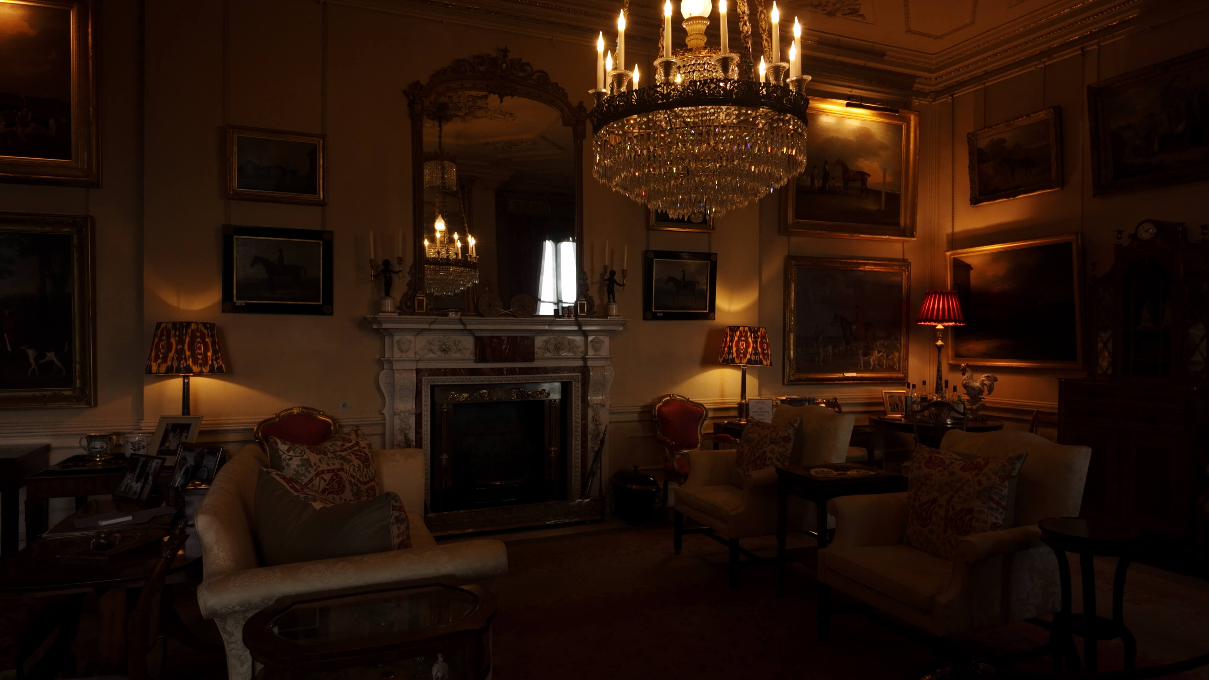 A beautifully arranged room showcasing a fireplace, a luxurious chandelier, and a framed mirror