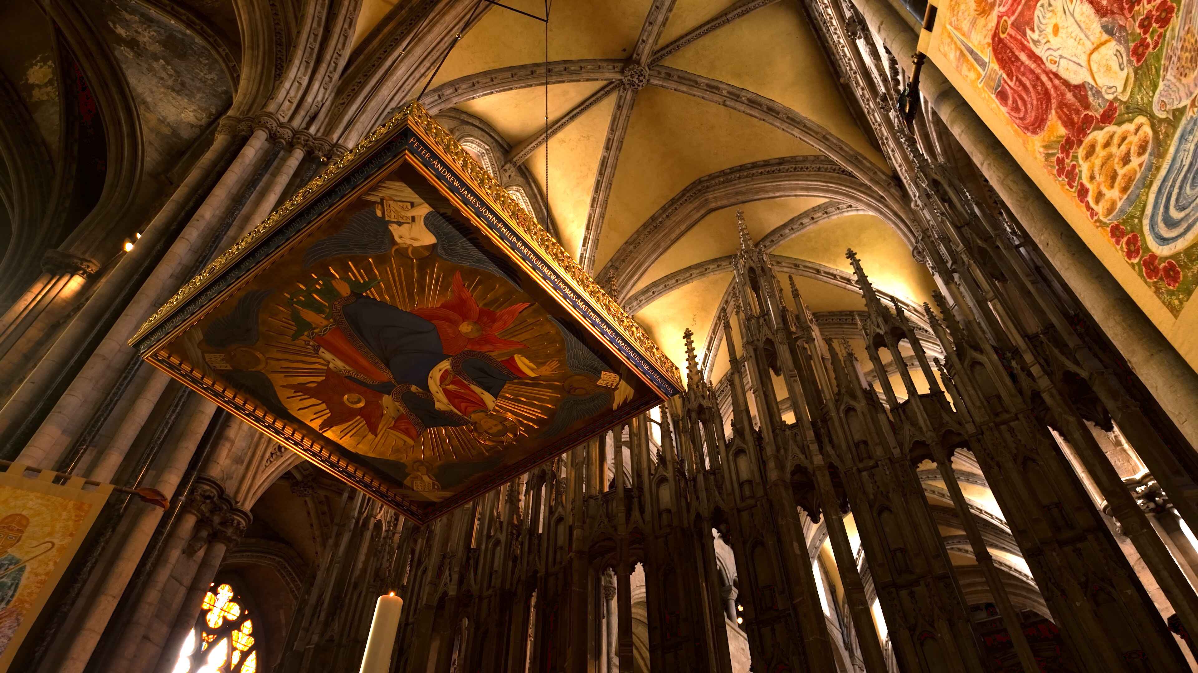  Interior of a cathedral featuring a large painting suspended from the ceiling
