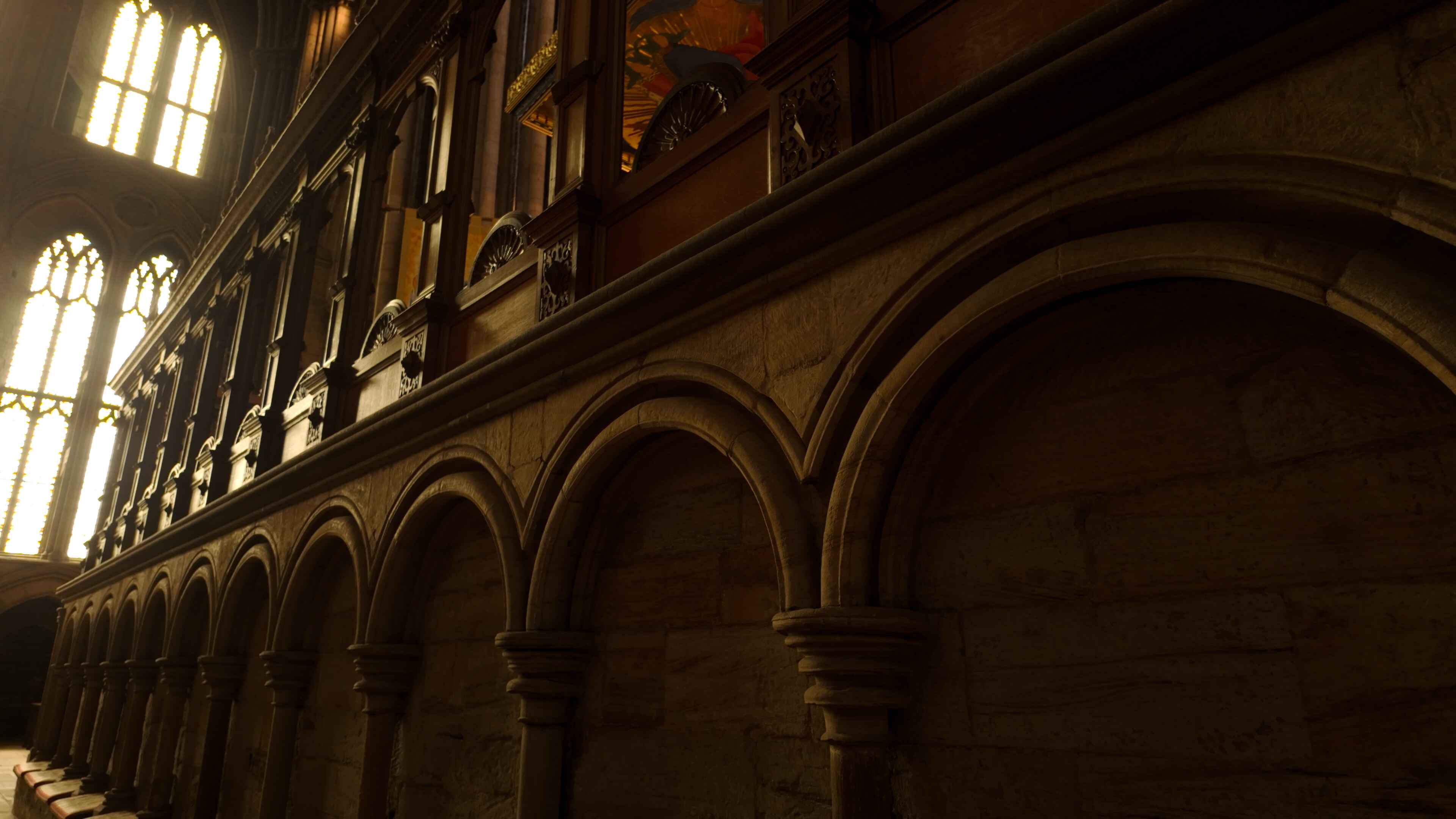 The sides of a mezzanine in a cathedral with archways and outdoor light to the back left